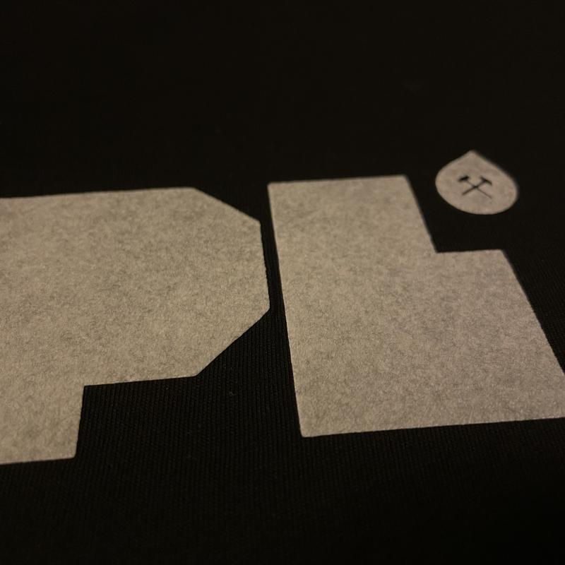 A T-shirt printed with Flock print, now dirty with lint, close-up