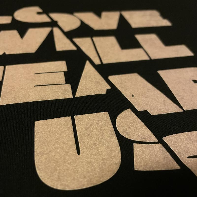 A T-shirt printed with Flock print, now dirty with lint, close-up